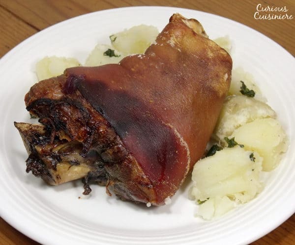 Schweinshaxe, or tender and juicy pork knuckle wrapped in a salty and roasted-crisp skin, is the quintessential Oktoberfest feast, perfect for pairing with a big stein of your favorite beer. | www.curiouscuisiniere.com 