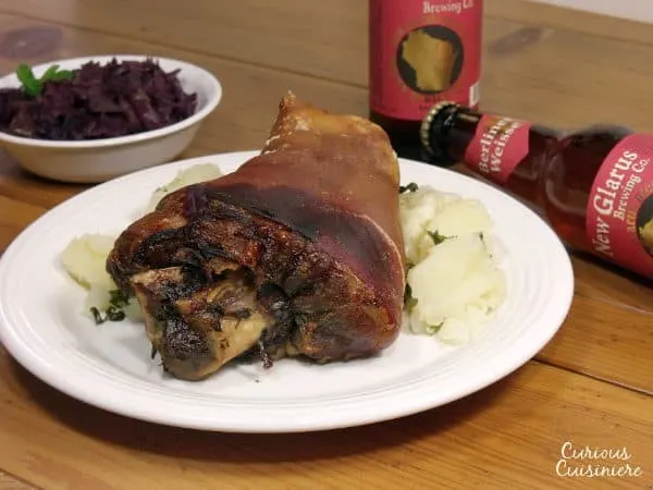 Schweinshaxe, or tender and juicy pork knuckle wrapped in a salty and roasted-crisp skin, is the quintessential Oktoberfest feast, perfect for pairing with a big stein of your favorite beer. | www.curiouscuisiniere.com 