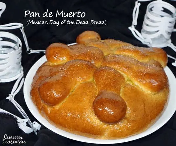 Pan de Muerto is a light and sweet Mexican Day of the Dead bread, traditionally spiced with ground anise and brushed with an orange glaze.