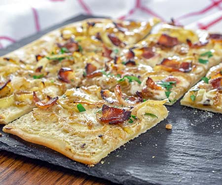 Flammekuchen, French Alsace pizza with bacon and caramelized onions.