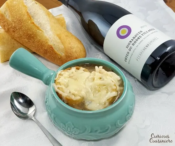Comforting French Onion Soup combines caramelized onions, crisp toast, and gooey cheese for one comforting dish. | www.curiouscuisiniere.com 