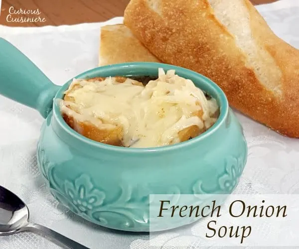 Comforting French Onion Soup combines caramelized onions, crisp toast, and gooey cheese for one comforting dish. | www.curiouscuisiniere.com 