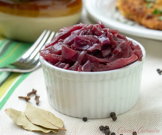 German Blaukraut Braised Red Cabbage in a small bowl with bay leaves and allspice berries. 