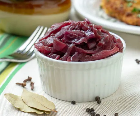 German Blaukraut Braised Red Cabbage in a small bowl with bay leaves and allspice berries. Small version