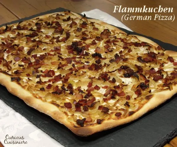 Bacon, caramelized onions, and a creamy base make up Flammkuchen, this classic German pizza, all on top of a cracker-thin, crispy crust. | www.curiouscuisiniere.com