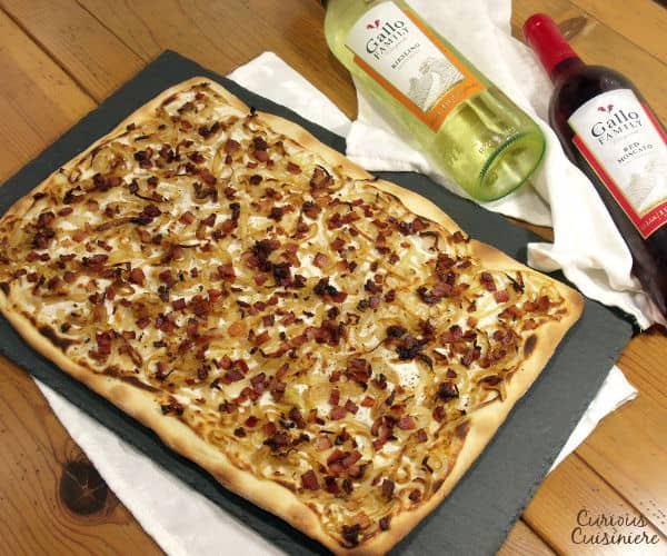 Bacon, caramelized onions, and a creamy base make up Flammkuchen, this classic German pizza, all on top of a cracker-thin, crispy crust. | www.curiouscuisiniere.com