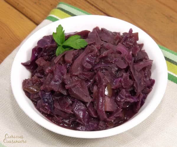 Sweet and tangy, slow braised red cabbage, Blaukraut, is a must-have side with any German meal and a tasty way to get anyone to enjoy cabbage. | www.curiouscuisiniere.com