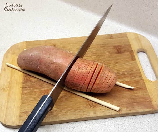 Hasselback sweet potatoes make for a beautifully presented holiday side dish. They're the perfect alternative to sweet potato casserole for your Thanksgiving table! | www.curiouscuisiniere.com