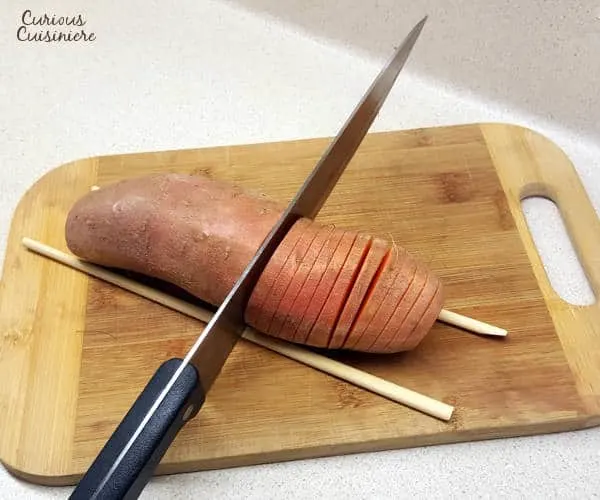 Hasselback sweet potatoes make for a beautifully presented holiday side dish. They're the perfect alternative to sweet potato casserole for your Thanksgiving table! | www.curiouscuisiniere.com