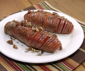 Hasselback potatoes make for a beautifully presented holiday side dish, and using sweet potatoes makes them the perfect addition to any Thanksgiving table! | www.curiouscuisiniere.com