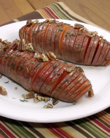Hasselback potatoes make for a beautifully presented holiday side dish, and using sweet potatoes makes them the perfect addition to any Thanksgiving table! | www.curiouscuisiniere.com