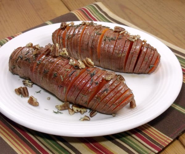 Hasselback potatoes make for a beautifully presented holiday side dish, and using sweet potatoes makes them the perfect addition to any Thanksgiving table! | www.curiouscuisiniere.com