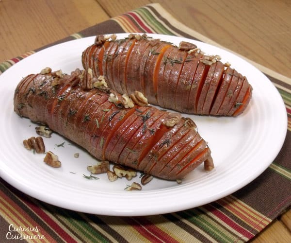 Hasselback sweet potatoes make for a beautifully presented holiday side dish. They're the perfect alternative to sweet potato casserole for your Thanksgiving table! | www.curiouscuisiniere.com
