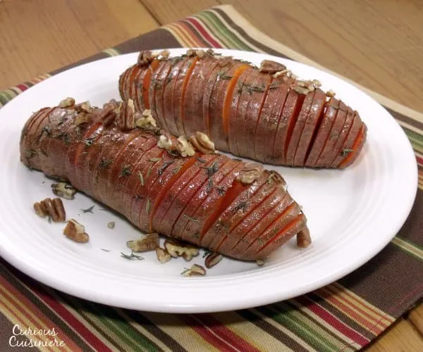 Hasselback sweet potatoes make for a beautifully presented holiday side dish. They're the perfect alternative to sweet potato casserole for your Thanksgiving table! | www.curiouscuisiniere.com