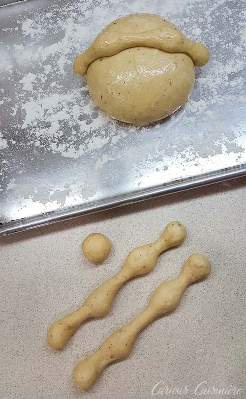Shaping dough to make Mexican Day of the Dead Bread Pan de Muerto