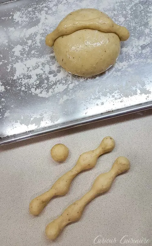 Shaping dough to make Mexican Day of the Dead Bread Pan de Muerto