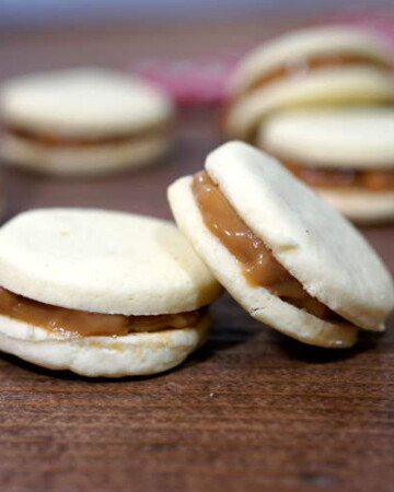 Creamy dulce de leche, sandwiched between two crisp and buttery shortbread cookies makes these Argentinian Alfajores a recipe worth indulging in for the holidays. | www.curiouscuisiniere.com