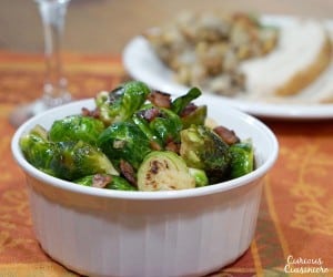 Slightly sweet, slightly salty this recipe for Maple Bacon Roasted Brussels Sprouts is sure to be a winning side dish on your holiday table or any day! | www.curiouscuisiniere.com