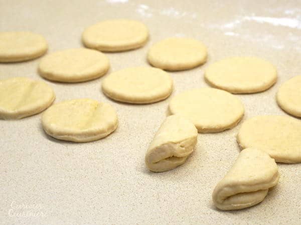 This recipe for soft and buttery Parker House Rolls makes a classic American dinner roll, perfect for a holiday or any occasion. | www.curiouscuisiniere.com