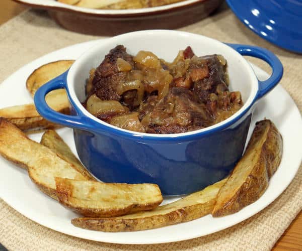 Carbonade Flamande is full of caramelized onions, bacon, and slow cooked beef making this Beef Stew from Belgium the perfect recipe for winter comfort food. | www.curiouscuisiniere.com
