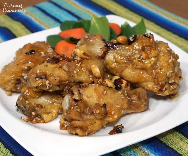 Dak Kang Jung, or Korean Sweet and Spicy Chicken Wings are the perfect combo of sticky sweetness and red chili spice. With baked "fried" and traditional deep fried versions, this recipe makes a great game day appetizer! | www.CuriousCuisiniere.com