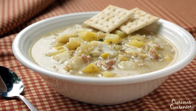 This recipe for New England Seafood Chowder creates a versatile and tasty soup, that is perfect for warming up on a cold winter day. Use whatever seafood you like to fit this chowder to your family's tastes. | www.CuriousCuisiniere.com