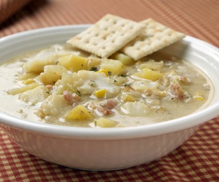 This recipe for New England Seafood Chowder creates a versatile and tasty soup, that is perfect for warming up on a cold winter day. Use whatever seafood you like to fit this chowder to your family's tastes. | www.CuriousCuisiniere.com