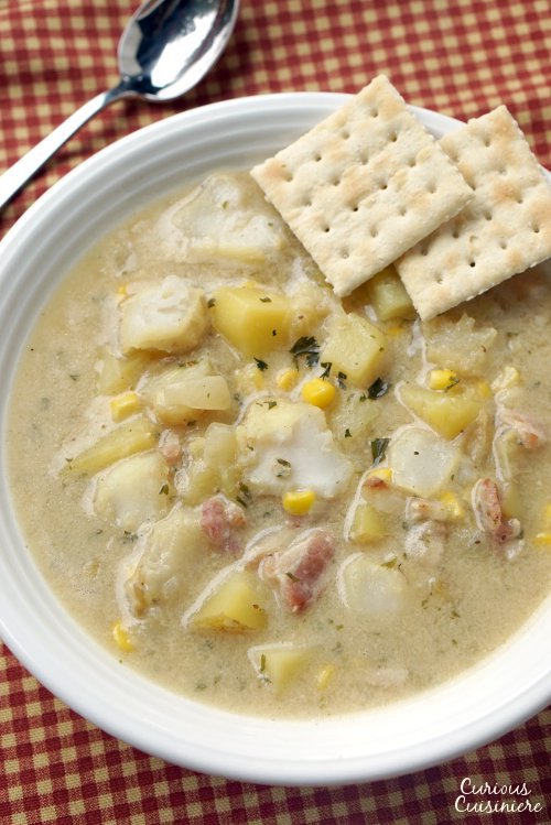 This recipe for New England Seafood Chowder creates a versatile and tasty soup, that is perfect for warming up on a cold winter day. Use whatever seafood you like to fit this chowder to your family's tastes. | www.CuriousCuisiniere.com