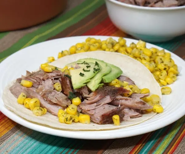 Puerto Rican Pernil brings slow roasted pork to a whole new level with a robust garlic and oregano flavor and salty, crisp skin. | www.CuriousCuisiniere.com