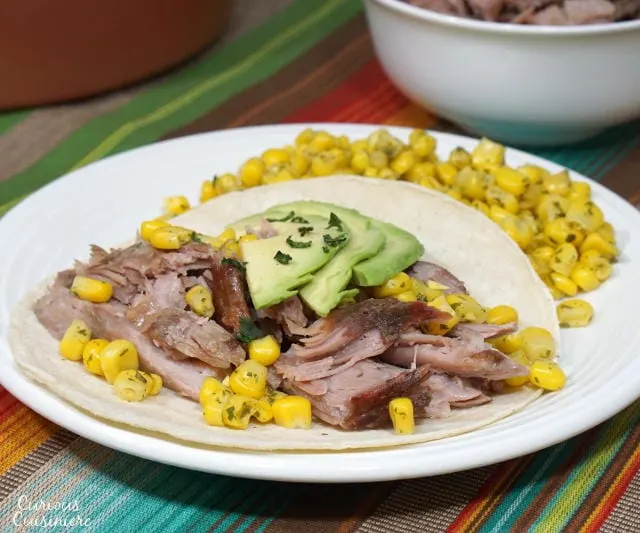 Puerto Rican Pernil brings slow roasted pork to a whole new level with a robust garlic and oregano flavor and salty, crisp skin. | www.CuriousCuisiniere.com