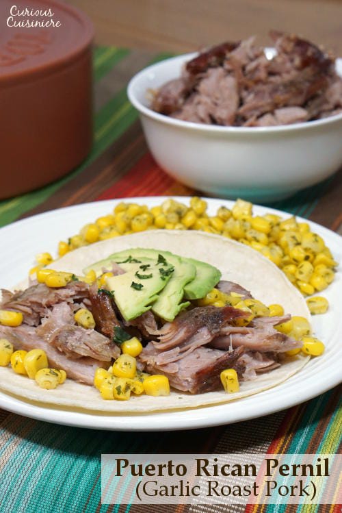 Puerto Rican Pernil brings slow roasted pork to a whole new level with a robust garlic and oregano flavor and salty, crisp skin. | www.CuriousCuisiniere.com