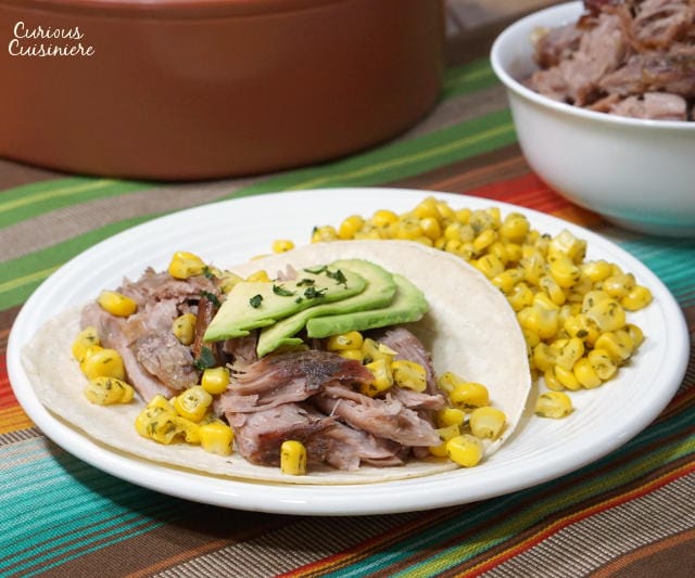Puerto Rican Pernil brings slow roasted pork to a whole new level with a robust garlic and oregano flavor and salty, crisp skin. | www.CuriousCuisiniere.com