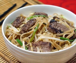 Beef Chow Fun is a Cantonese stir fry recipe using rice noodles, beef, and bean sprouts. You don't need to order takeout to have this easy, flavorful dinner! | www.CuriousCuisiniere.com