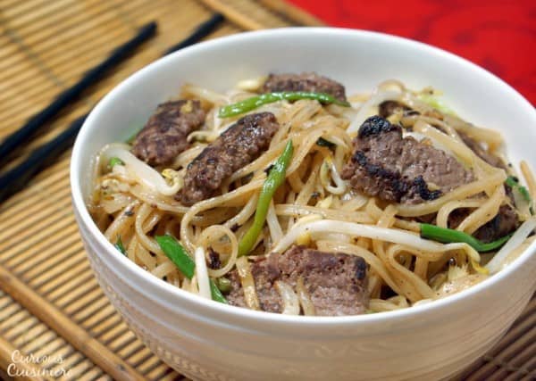 Beef Chow Fun is a Cantonese stir fry recipe using rice noodles, beef, and bean sprouts. You don't need to order takeout to have this easy, flavorful dinner! | www.CuriousCuisiniere.com