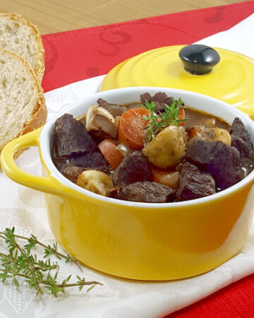 Beef, braised in deep red wine, makes the classic French Boeuf Bourguignon a recipe for the perfect winter comfort food. | www.CuriousCuisiniere.com