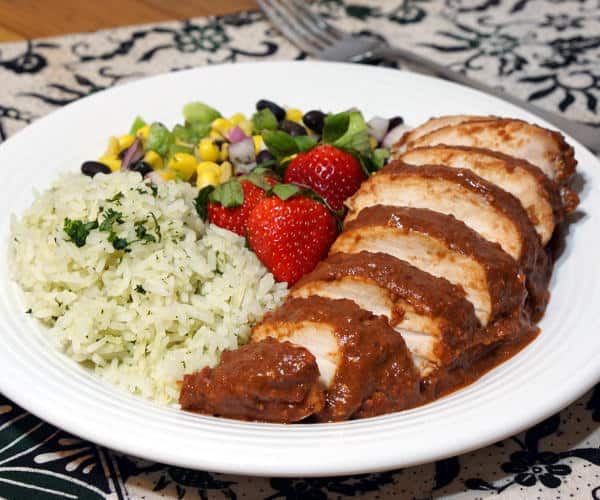 Light and bright strawberries take on a savory depth in this recipe for Chicken with Strawberry Mole Sauce. If you love mole and strawberries, you need to try this unique twist on the classic Mexican mole. | www.CuriousCuisiniere.com
