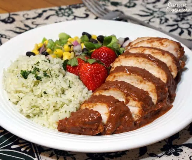 Light and bright strawberries take on a savory depth in this recipe for Chicken with Strawberry Mole Sauce. If you love mole and strawberries, you need to try this unique twist on the classic Mexican mole. | www.CuriousCuisiniere.com 