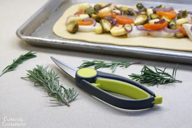 This rustic, free-form Tarte Provencale is filled with flavorful roasted winter vegetables and creamy goat cheese. It is the perfect recipe for a comforting winter appetizer. | www.CuriousCuisiniere.com