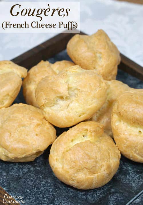 Gougères, or French Cheese Puffs, are light and airy, cheese-filled pastry bites with a crisp outside and a soft, buttery inside. Once you make them, you'll want to serve this recipe as an appetizer at every party! | www.CuriousCuisiniere.com