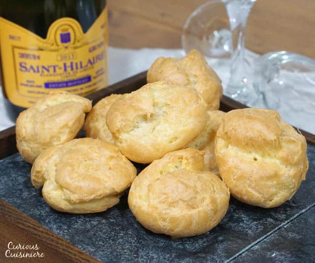Gougères, or French Cheese Puffs, are light and airy, cheese-filled pastry bites with a crisp outside and a soft, buttery inside. Once you make them, you'll want to serve this recipe as an appetizer at every party! | www.CuriousCuisiniere.com