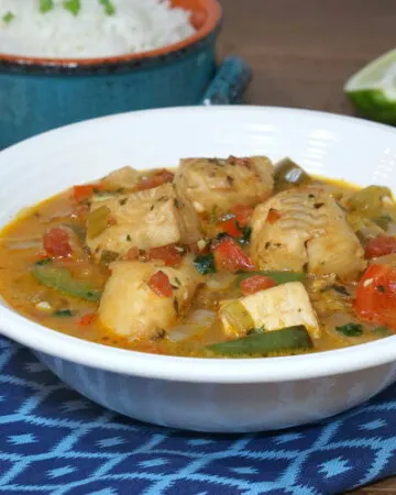 A light and tropical fish stew, Moqueca brings coconut milk and citrus together in a tasty Brazilian dinner recipe. | www.CuriousCuisiniere