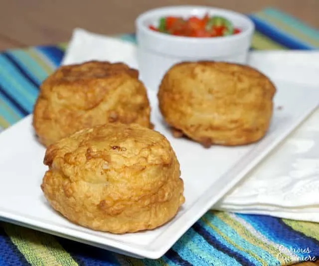 These fried potato balls will surprise you with their flavorful beef and rice center! The Colombian version of Papas Rellenas is the perfect recipe for a party appetizer or a fun dinner. | www.CuriousCuisiniere.com 