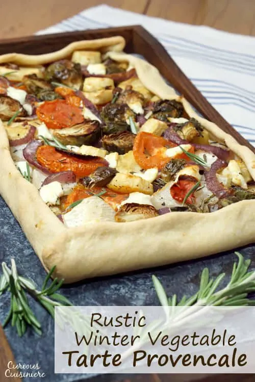 This rustic, free-form Tarte Provencale is filled with flavorful roasted winter vegetables and creamy goat cheese. It is the perfect recipe for a comforting winter appetizer. | www.CuriousCuisiniere.com