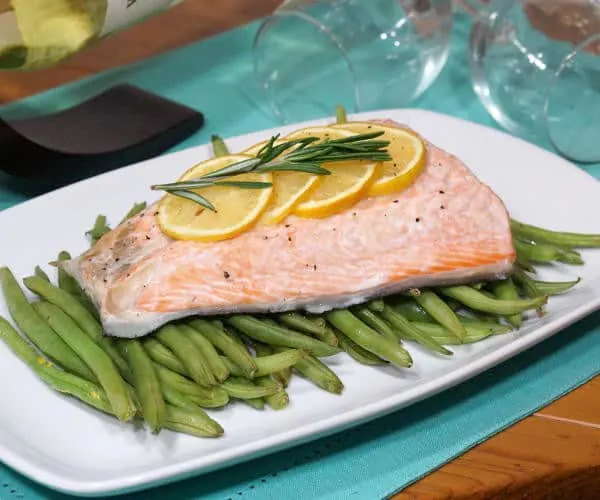 This quick and healthy Salmon en Papillote brings light lemon and earthy rosemary together in a beautifully steamed package for a dinner recipe that is simple to prepare and easy to clean up. | www.CuriousCuisiniere.com