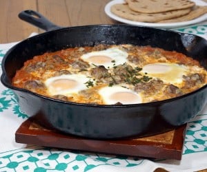 Kefta Mkaouara is a Moroccan dish made up of tiny meatballs, simmered in a flavorful tomato sauce and crowned with poached eggs. | www.CuriousCuisiniere.com