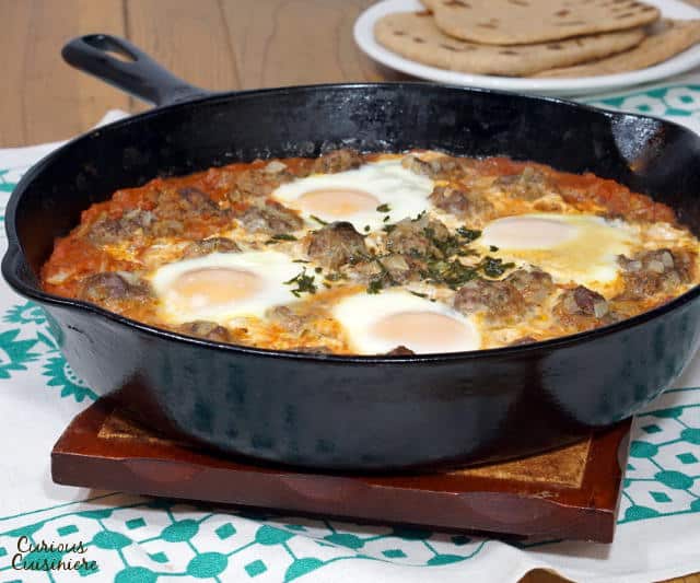 Kefta Mkaouara is a Moroccan dish made up of tiny meatballs, simmered in a flavorful tomato sauce and crowned with poached eggs. | www.CuriousCuisiniere.com