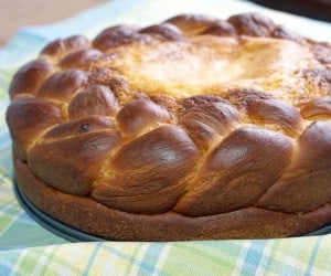 Pasca is a festive Romanian Easter Bread made up of a soft, panettone-like bread that is filled with a cheesecake center. It is the perfect recipe for a celebration! | www.CuriousCuisiniere.com