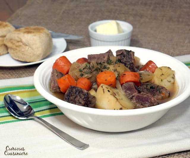 This slow cooker Irish Beef Stew recipe brings simple, traditional ingredients together to create an incredibly comforting meal. | www.CuriousCuisiniere.com 