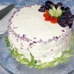A Swedish Sandwich Cake is the perfect centerpiece for a spring party. Bright, fresh, and fun to prepare, make this recipe for your next picnic! | www.CuriousCuisiniere.com