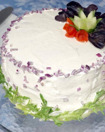 A Swedish Sandwich Cake is the perfect centerpiece for a spring party. Bright, fresh, and fun to prepare, make this recipe for your next picnic! | www.CuriousCuisiniere.com